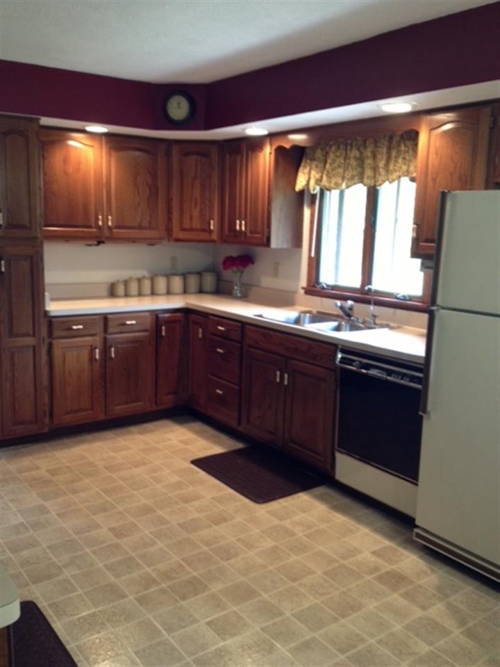 3613 East Oak Grove Road Byron, IL 61010 - Photo 11 of 24 a kitchen with stainless steel appliances granite countertop a stove a sink and a microwave