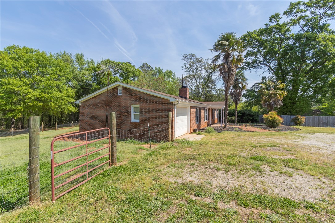 820 Travis Road Anderson, SC 29626 - Photo 4 of 46 This brick ranch offers a blend of classic charm and natural surroundings.