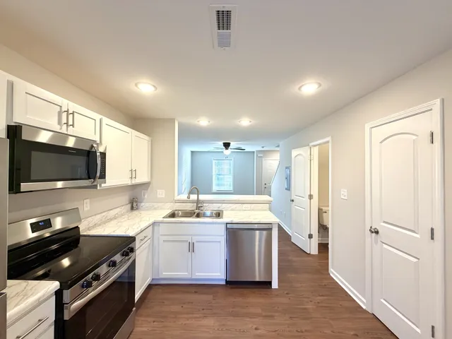 a kitchen with a sink stainless steel appliances and cabinets