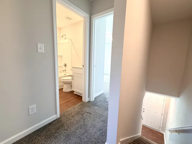 a view of an empty room and a window