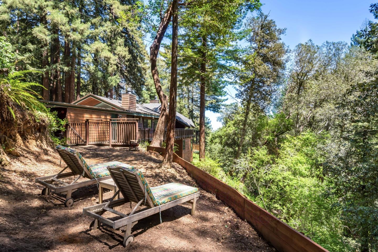 147 Summit Road Woodside, CA 94062 - Photo 25 of 32 a view of a wooden chairs and table in a backyard