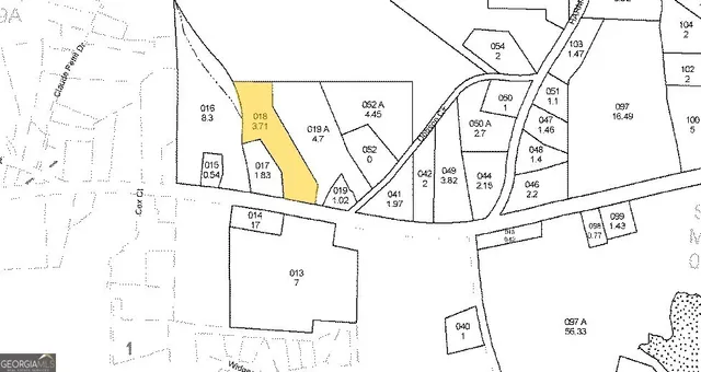 a white house sitting next to a road