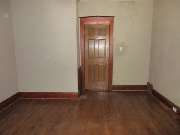 a view of an empty room with closet area