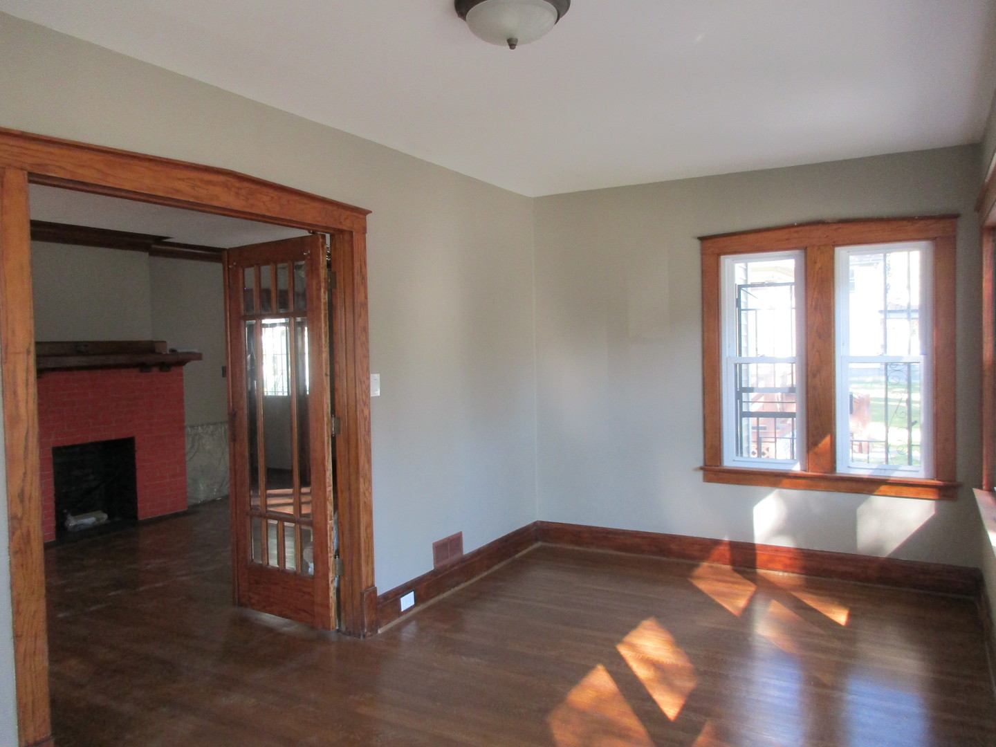 369 South Chicago Avenue Kankakee, IL 60901 - Photo 9 of 40 a view of a livingroom with wooden floor and a fireplace