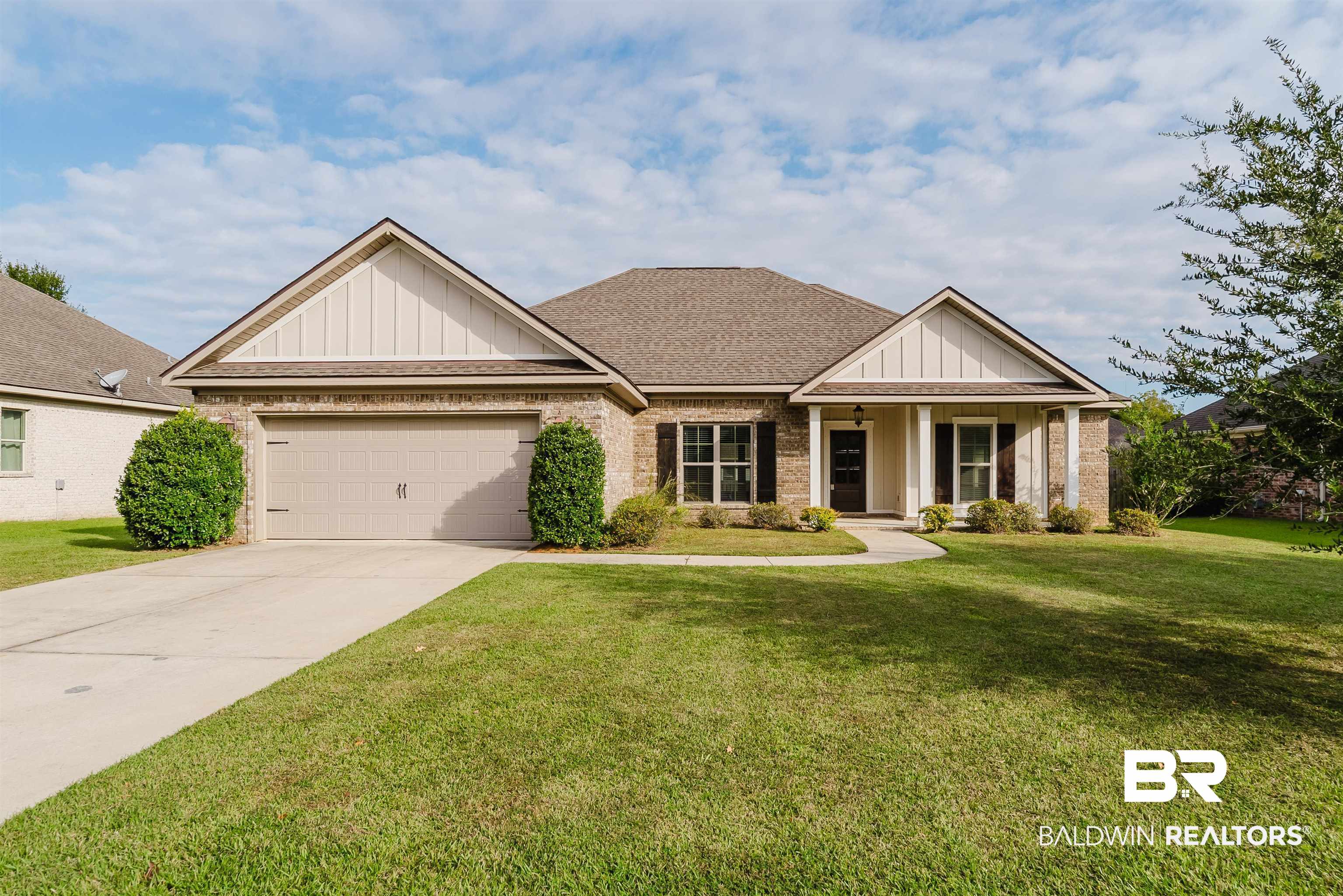 237 Hawthorne Circle Fairhope, AL 36532 - Photo 1 of 14 Craftsman-style home featuring board and batten siding, brick siding, a porch, and a front lawn