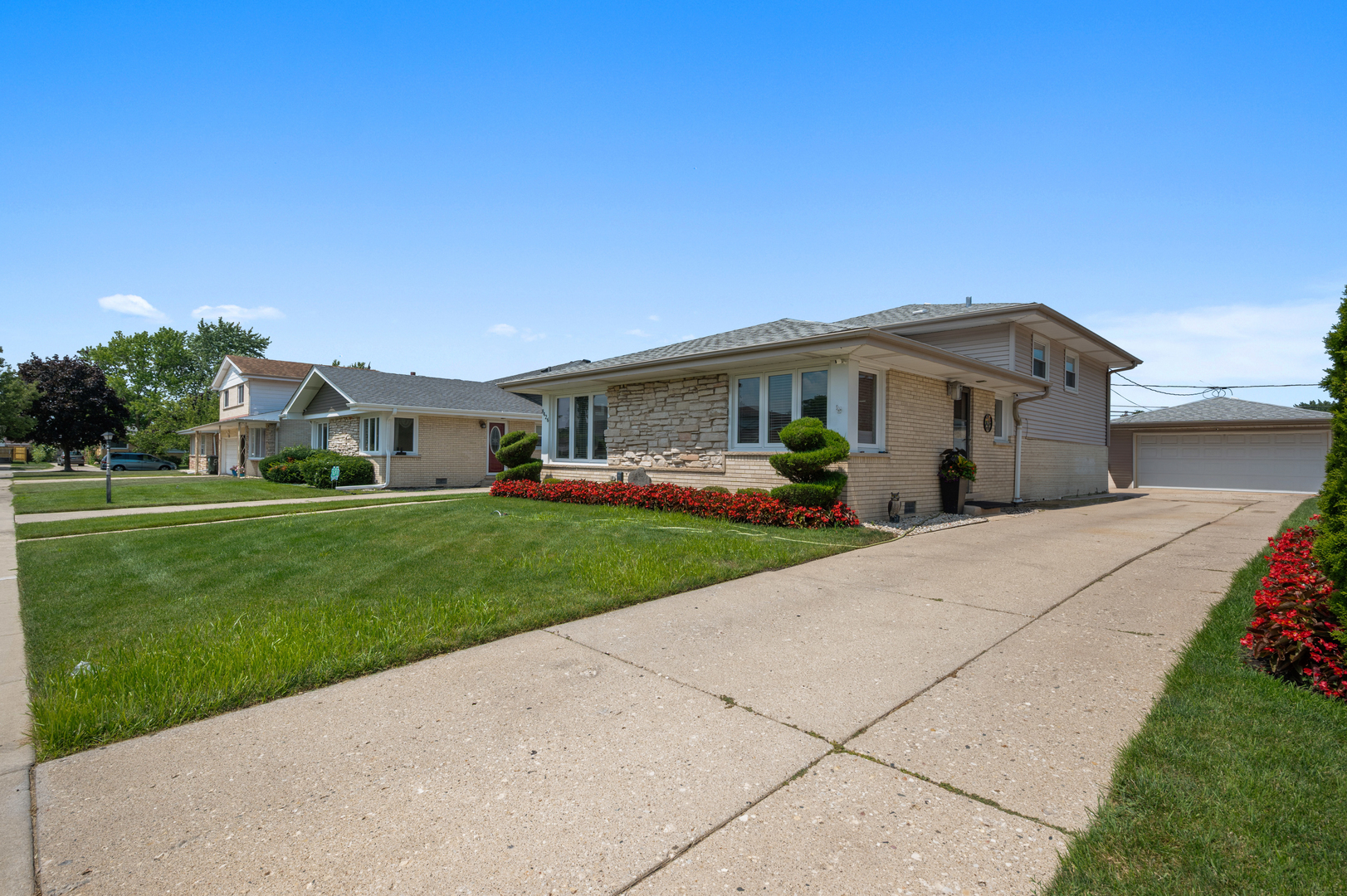 8426 West Betty Terrace Niles, IL 60714 - Photo 1 of 40 a front view of a house with a yard and potted plants