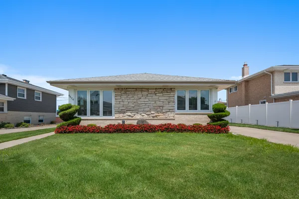 a front view of house with yard and green space