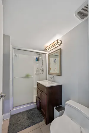 a bathroom with a toilet a sink and mirror