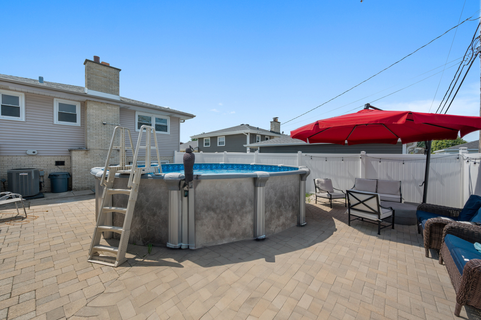 8426 West Betty Terrace Niles, IL 60714 - Photo 30 of 40 a view of a patio with a table and chairs under an umbrella