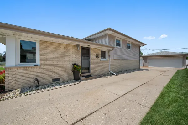 a backyard of a house with potted plants