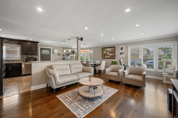 a living room with furniture and a wooden floor