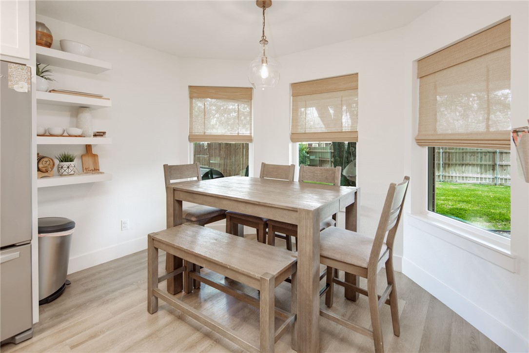 4700 Kensington Road Bryan, TX 77802 - Photo 13 of 31 Bright dining area featuring wood-finish flooring and a contemporary pendant light fixture