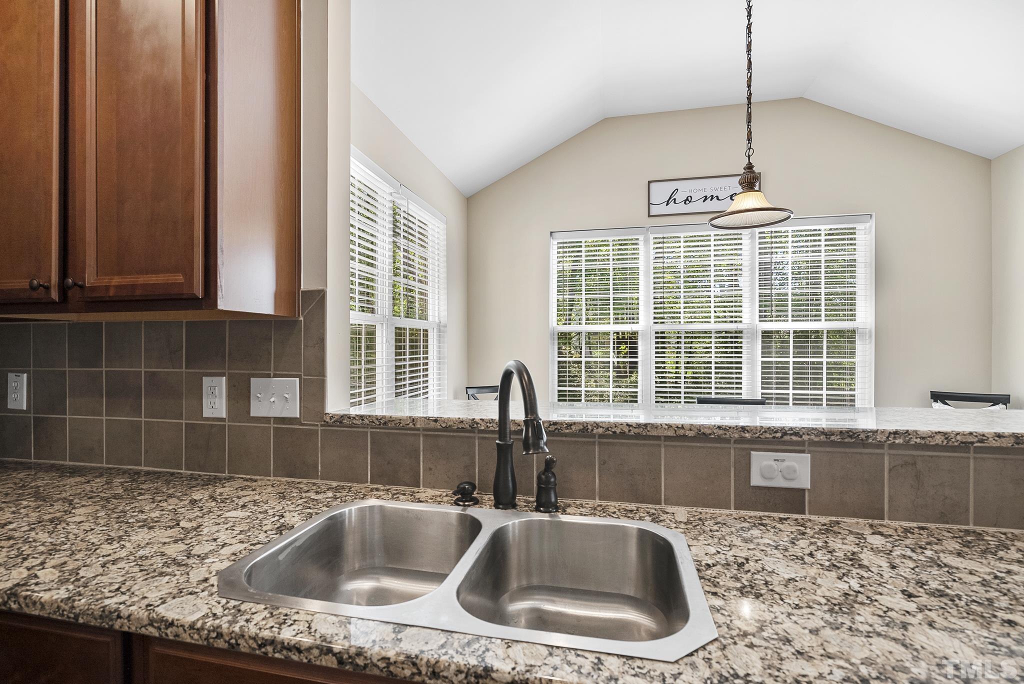213 Forbes Road Wake Forest, NC 27587 - Photo 13 of 41 a kitchen with granite countertop a sink and a counter top space