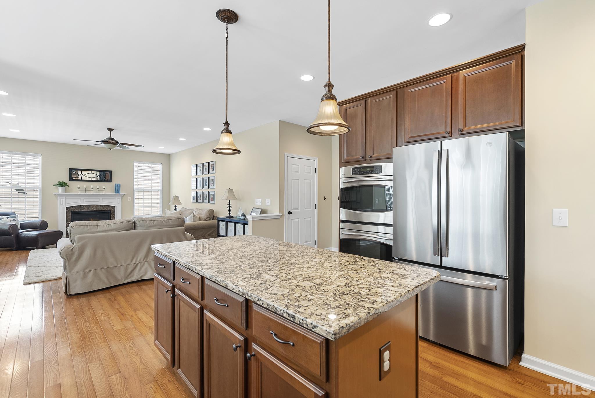 213 Forbes Road Wake Forest, NC 27587 - Photo 15 of 41 a kitchen with kitchen island a counter top space stainless steel appliances and wooden floor