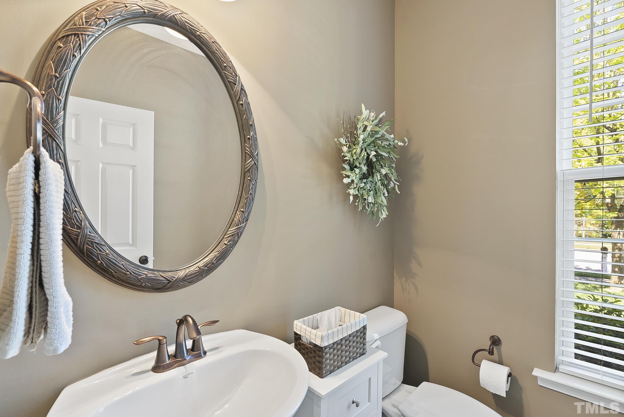 213 Forbes Road Wake Forest, NC 27587 - Photo 18 of 41 a bathroom with a toilet a sink and a mirror