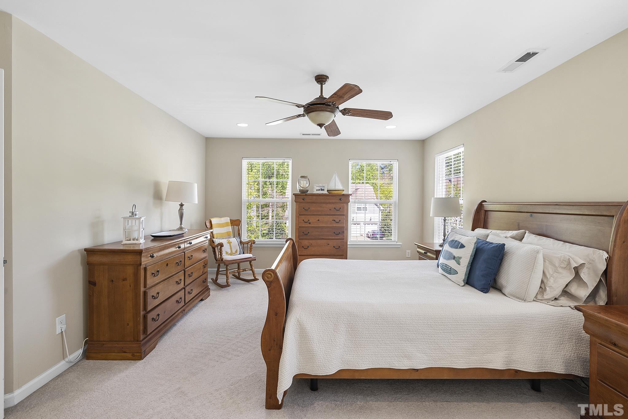 213 Forbes Road Wake Forest, NC 27587 - Photo 20 of 41 a bedroom with a bed chandelier and a window