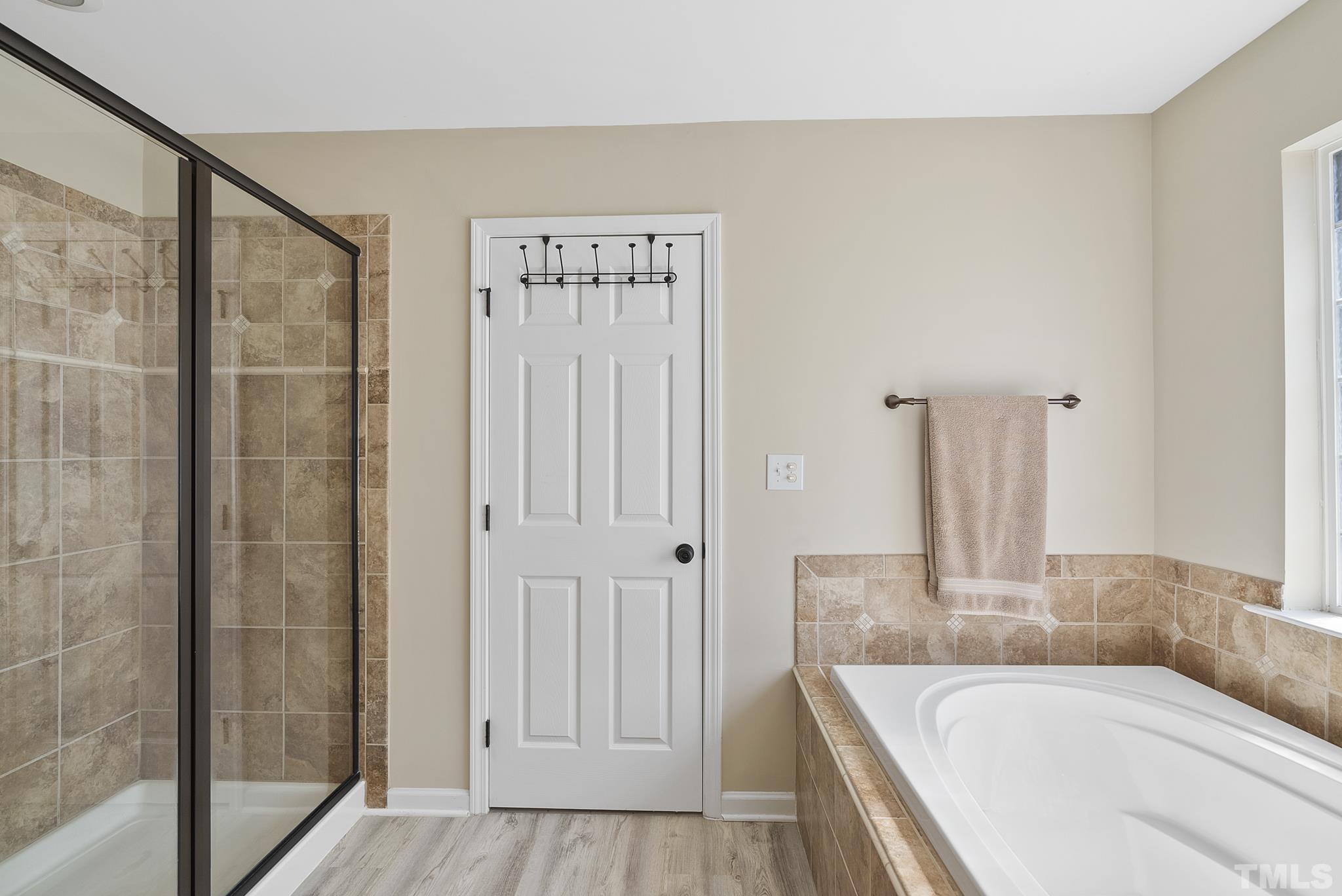 213 Forbes Road Wake Forest, NC 27587 - Photo 23 of 41 a bathroom with a tub and shower