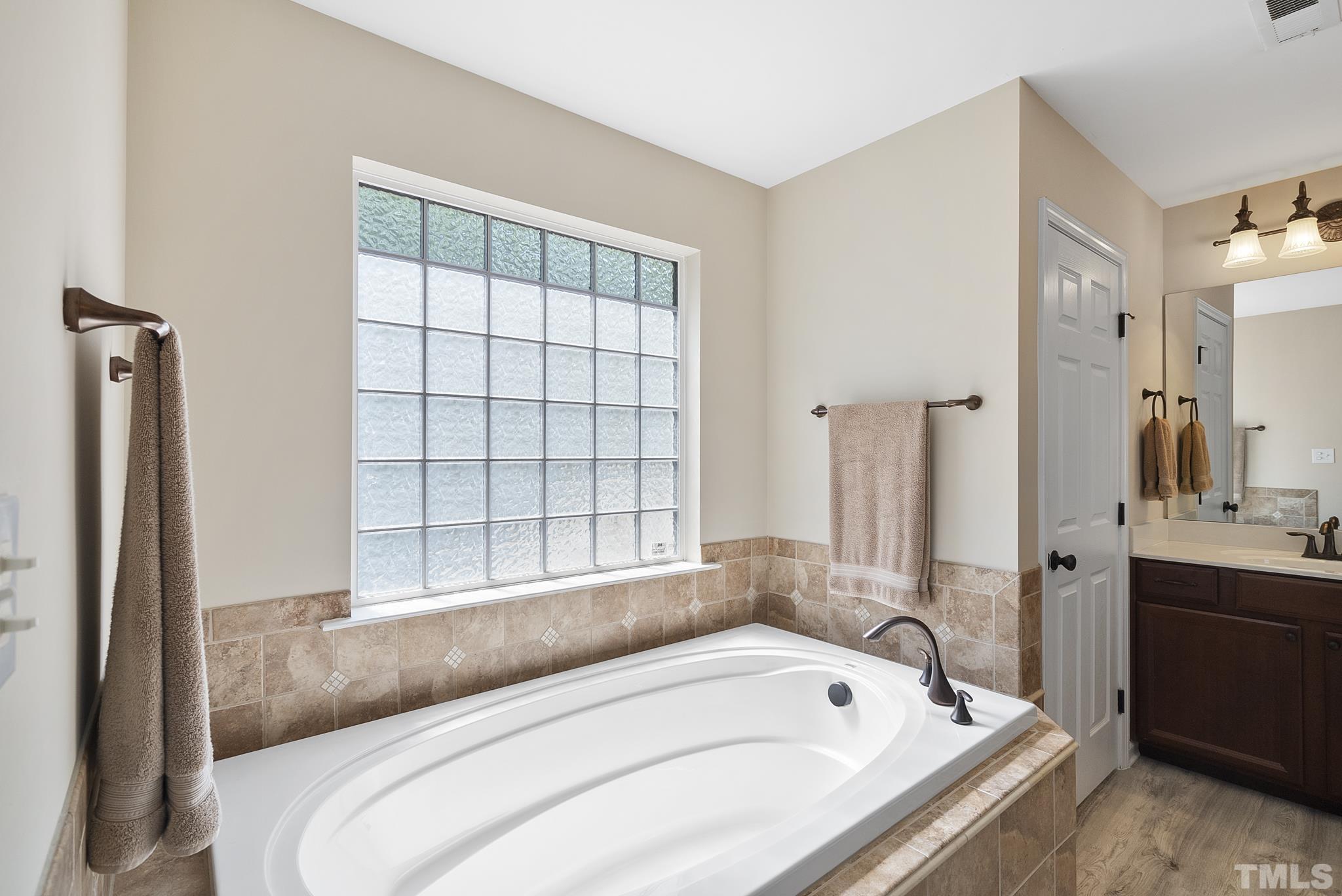213 Forbes Road Wake Forest, NC 27587 - Photo 24 of 41 a bathroom with a tub sink and mirror