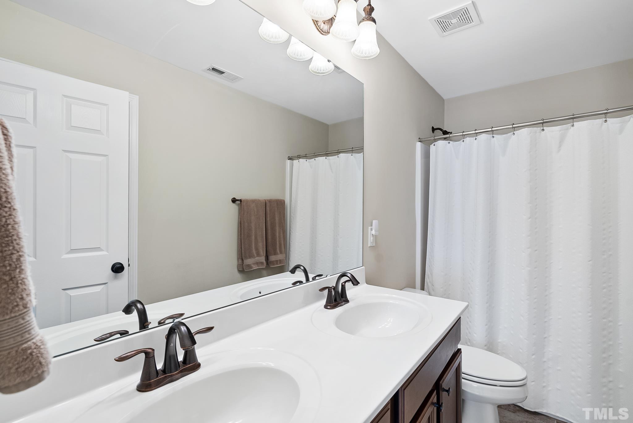 213 Forbes Road Wake Forest, NC 27587 - Photo 27 of 41 a bathroom with a sink a toilet and shower