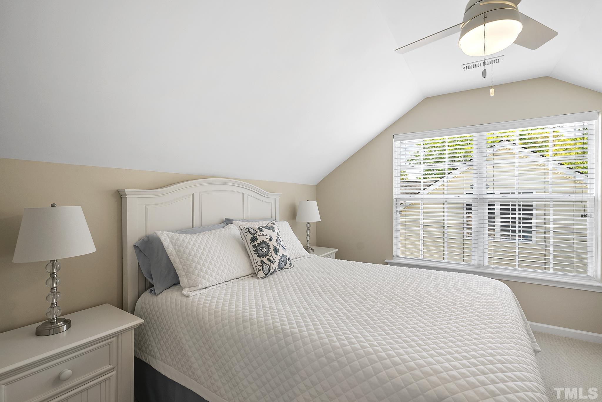 213 Forbes Road Wake Forest, NC 27587 - Photo 34 of 41 a bedroom with a bed and a table lamp