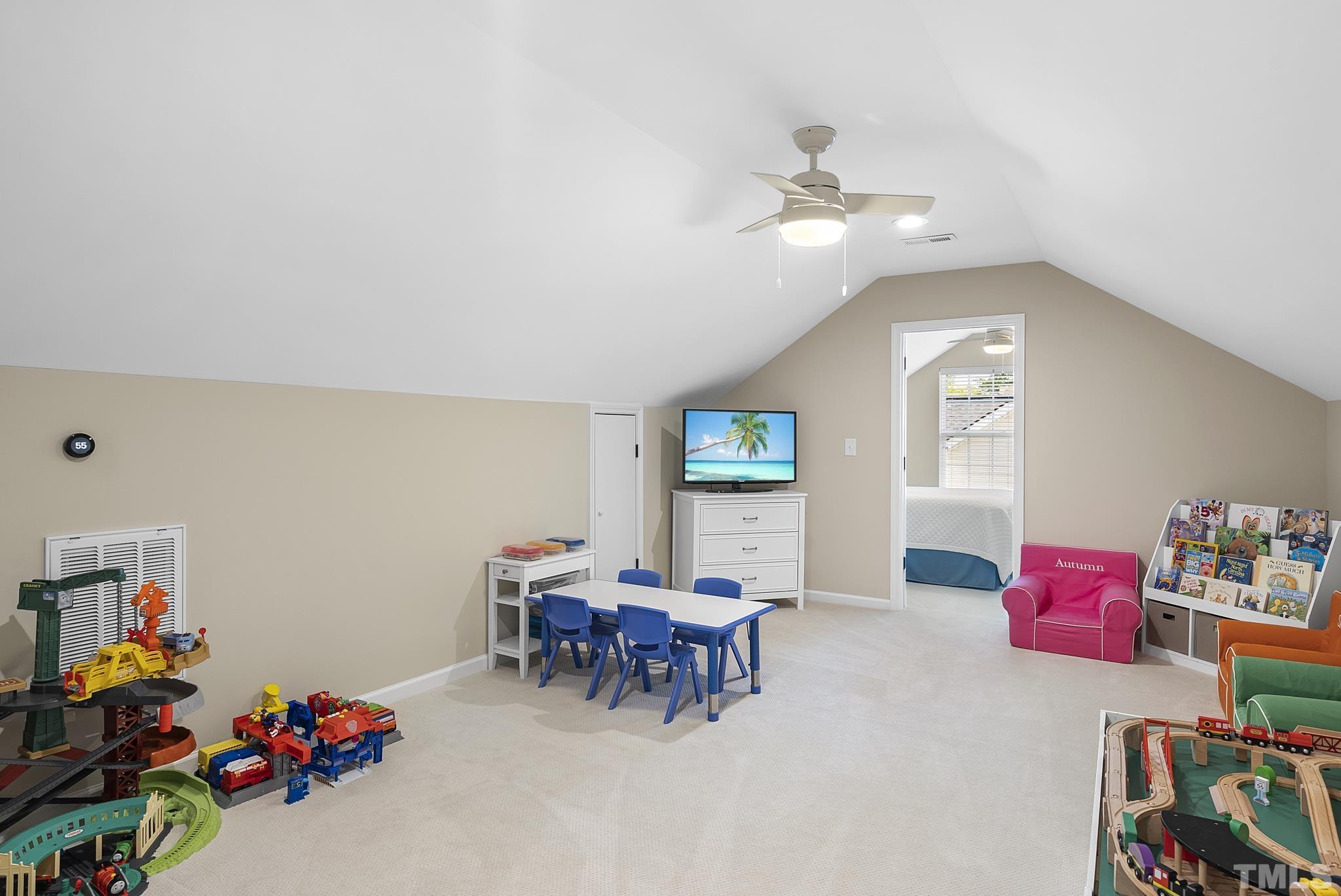 213 Forbes Road Wake Forest, NC 27587 - Photo 36 of 41 a living room with furniture and a chandelier