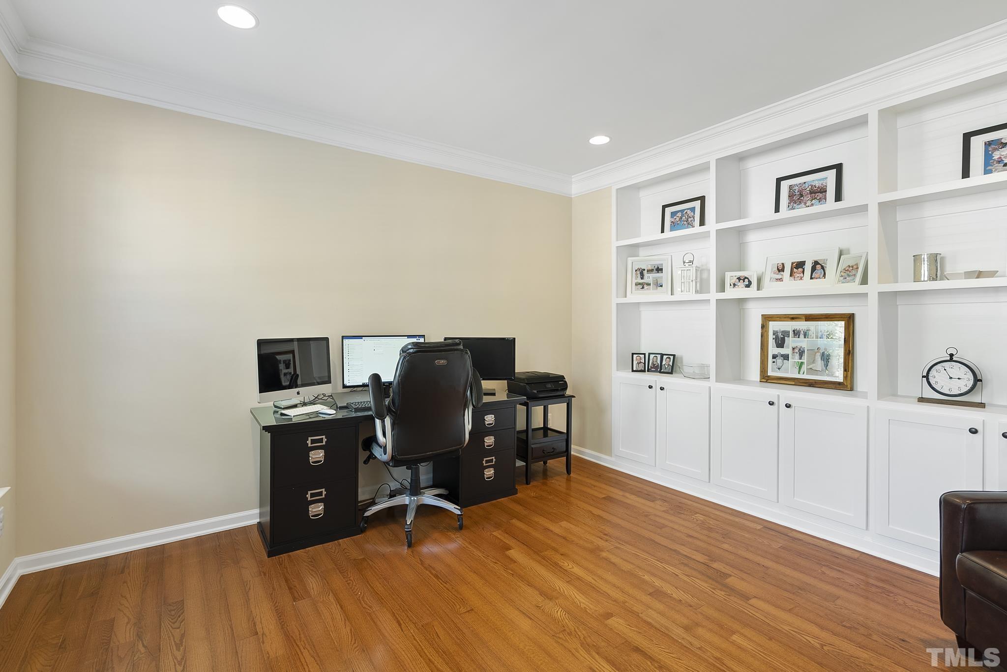 213 Forbes Road Wake Forest, NC 27587 - Photo 4 of 41 a view of a workspace with furniture and wooden floor