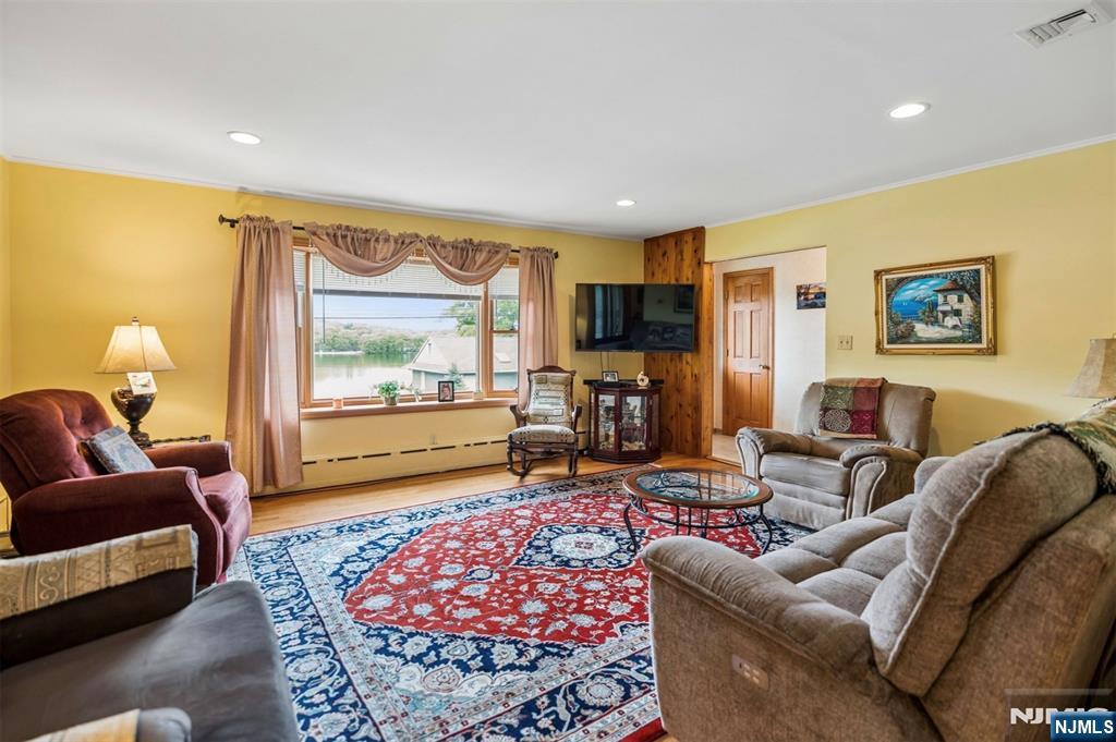 6 Waters Edge Butler, NJ 07405 - Photo 4 of 28 a living room with furniture or couch and a flat screen tv