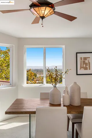 a view of a dining room with furniture and a window