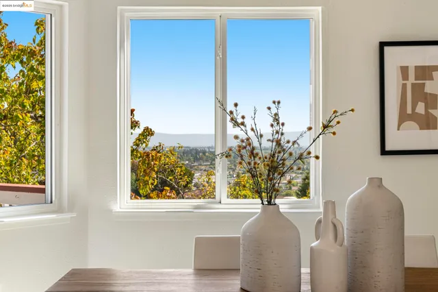 a kitchen with a table chairs refrigerator and cabinets