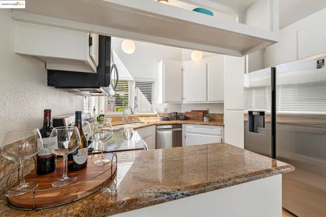 a kitchen with a sink appliances and cabinets
