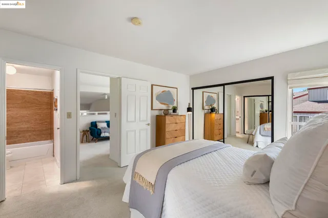a en suite bathroom with a granite countertop sink and a mirror