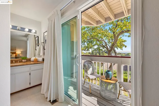 a bathroom with a granite countertop sink mirror vanity and toilet