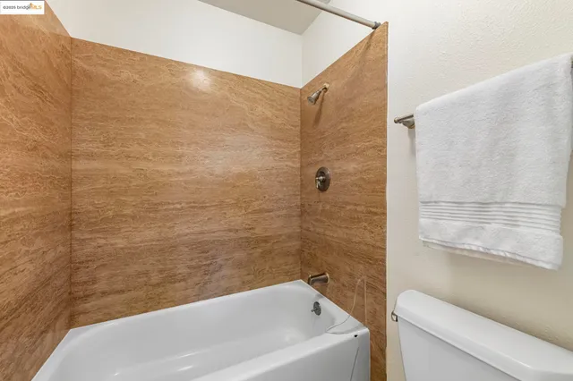 a balcony with wooden floor and outdoor seating