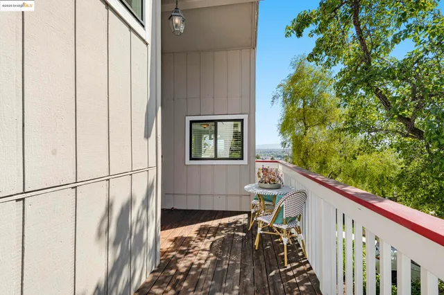 a balcony with wooden floor and outdoor space