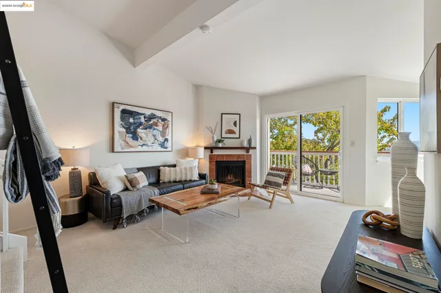 a living room with furniture large window and a flat screen tv