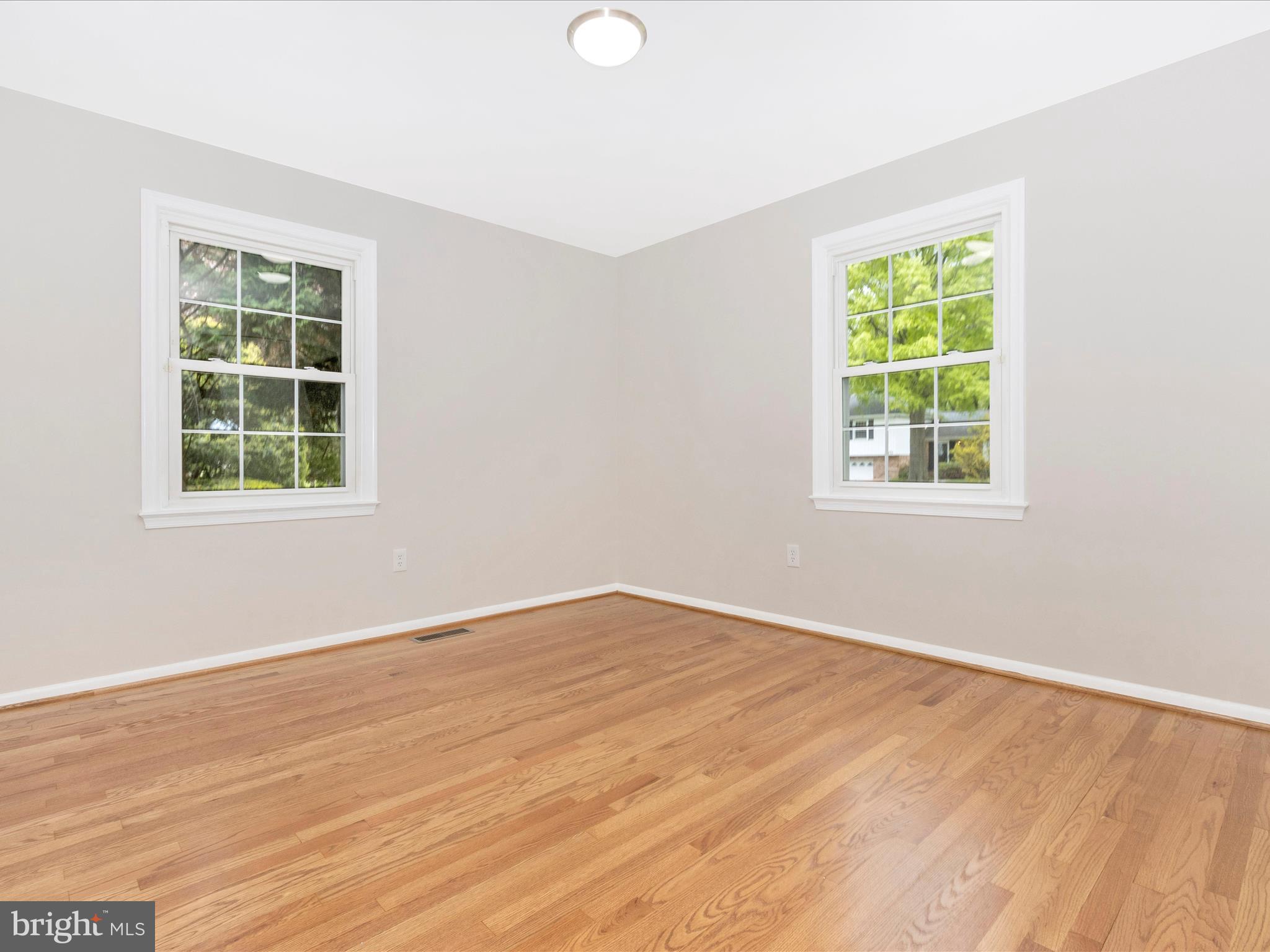 19453 Olney Mill Road Olney, MD 20832 - Photo 20 of 41 an empty room with wooden floor and windows