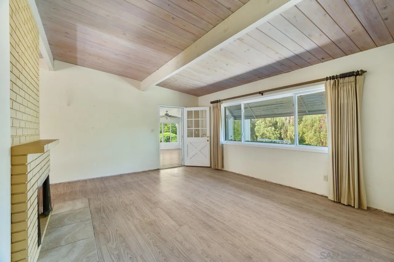 8670 Golden Ridge Road Lakeside, CA 92040 - Photo 13 of 31 an empty room with wooden floor and windows