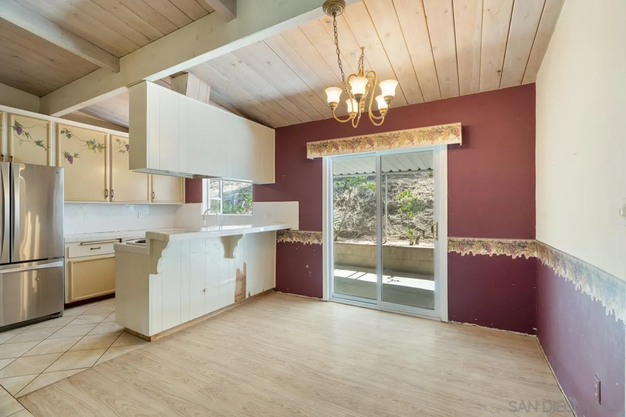 8670 Golden Ridge Road Lakeside, CA 92040 - Photo 16 of 31 a large kitchen with a window and stainless steel appliances