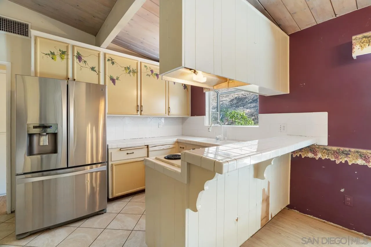 8670 Golden Ridge Road Lakeside, CA 92040 - Photo 19 of 31 a kitchen with stainless steel appliances granite countertop a refrigerator and a stove