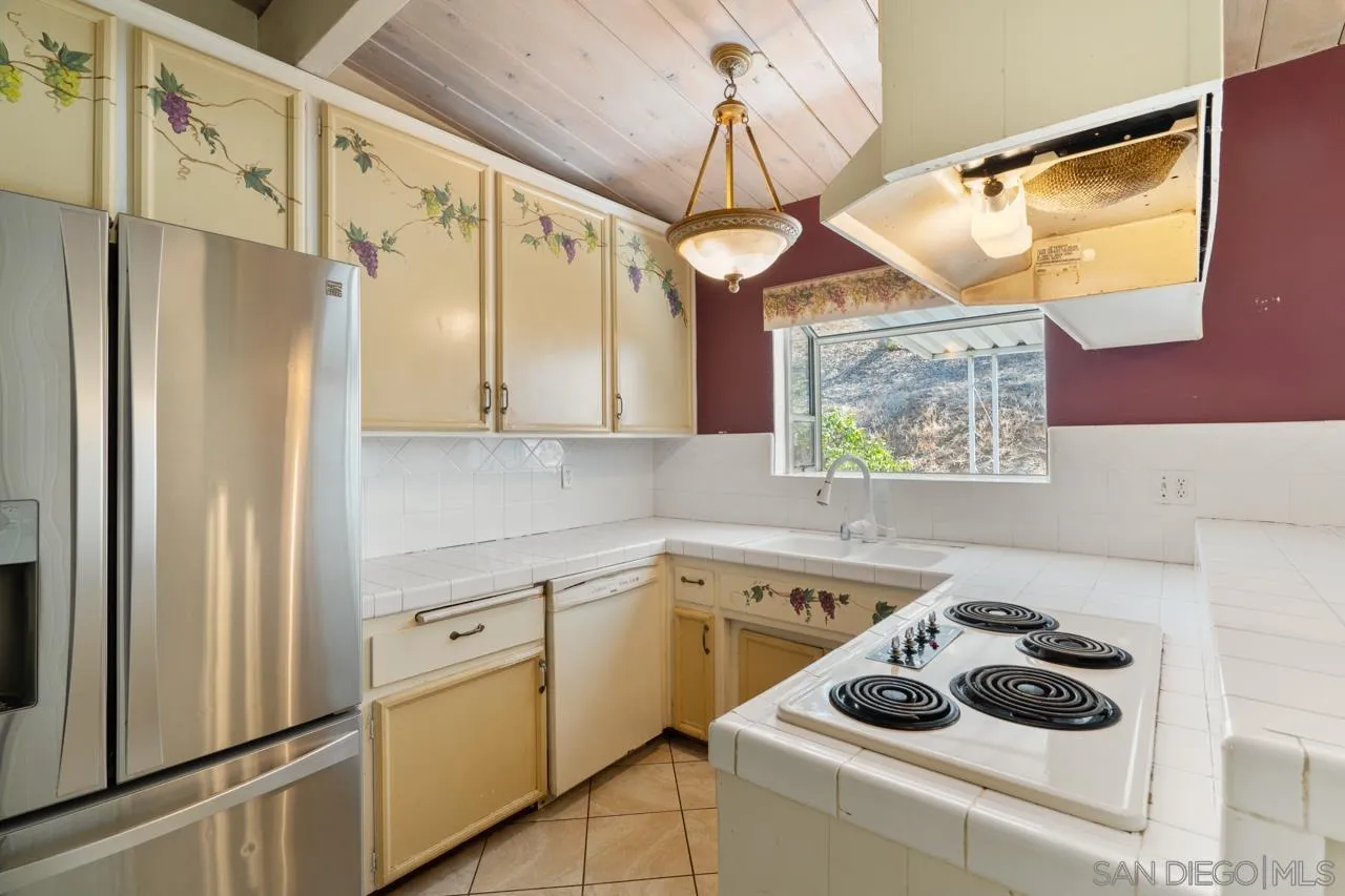 8670 Golden Ridge Road Lakeside, CA 92040 - Photo 20 of 31 a kitchen with white cabinets and white appliances