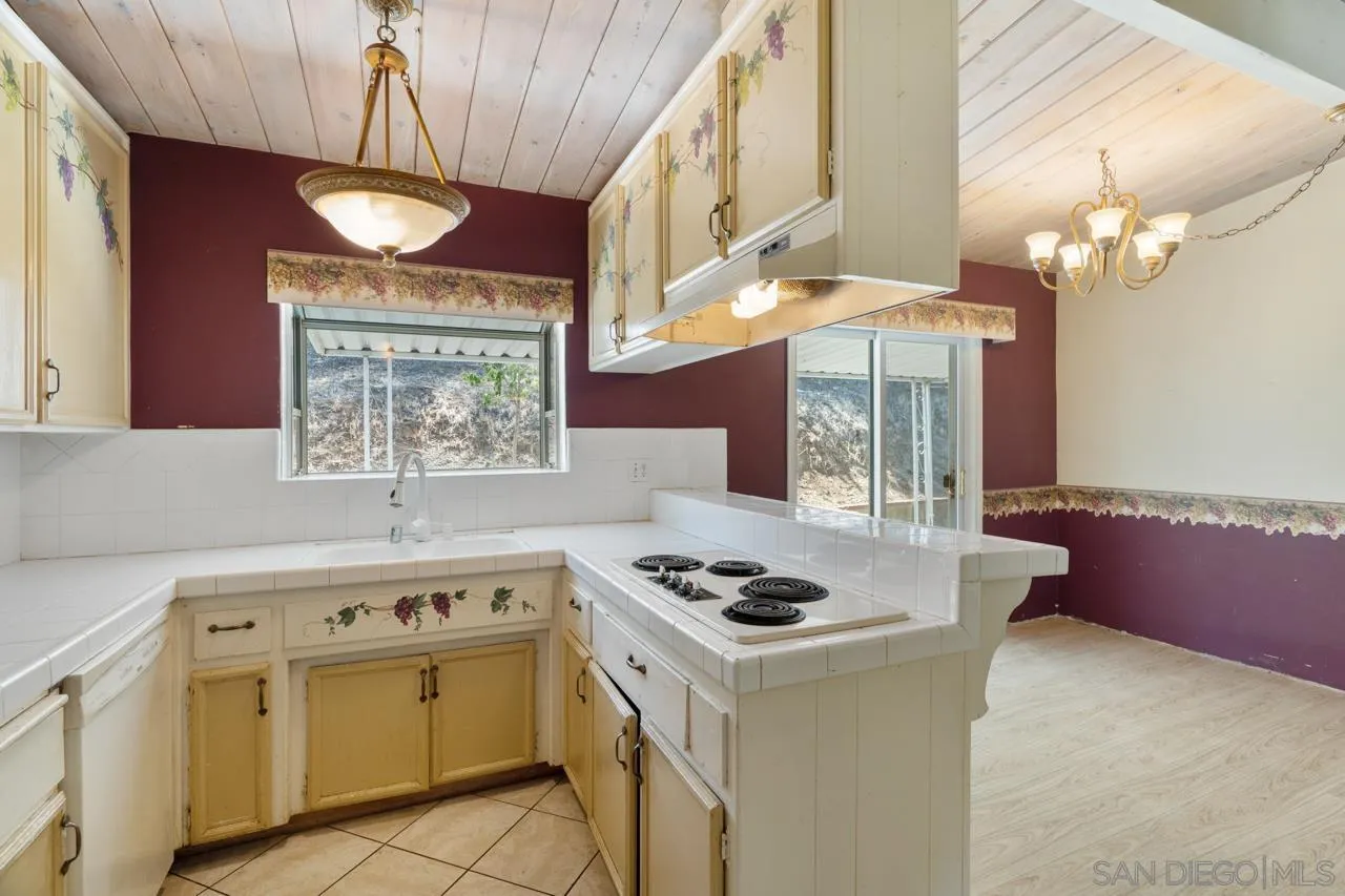8670 Golden Ridge Road Lakeside, CA 92040 - Photo 21 of 31 a kitchen with a stove a cabinets a sink and a stove