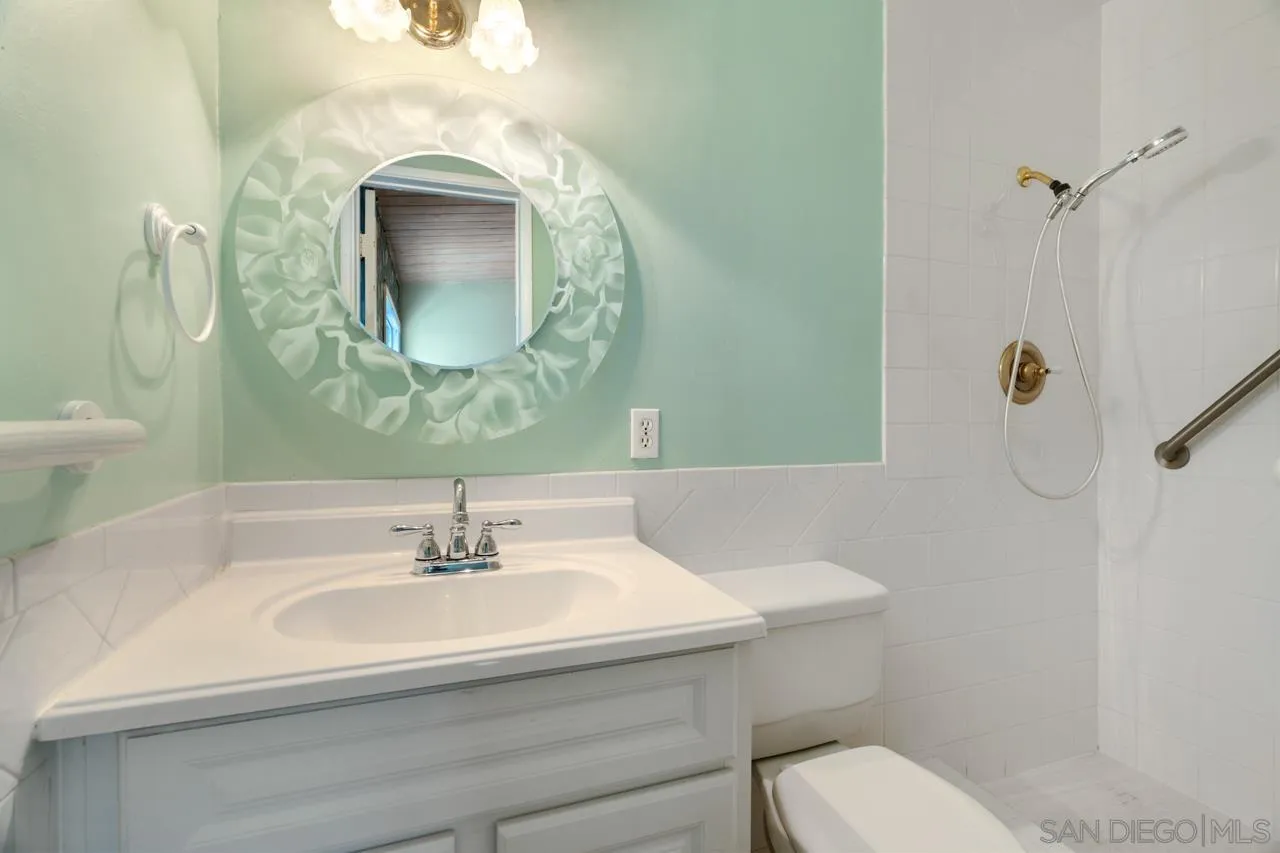 8670 Golden Ridge Road Lakeside, CA 92040 - Photo 25 of 31 a bathroom with a sink toilet and mirror