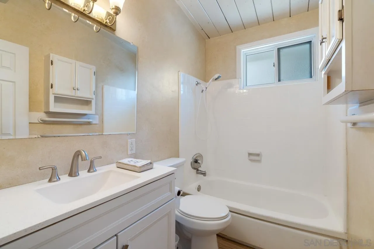 8670 Golden Ridge Road Lakeside, CA 92040 - Photo 27 of 31 a bathroom with a granite countertop sink toilet and shower