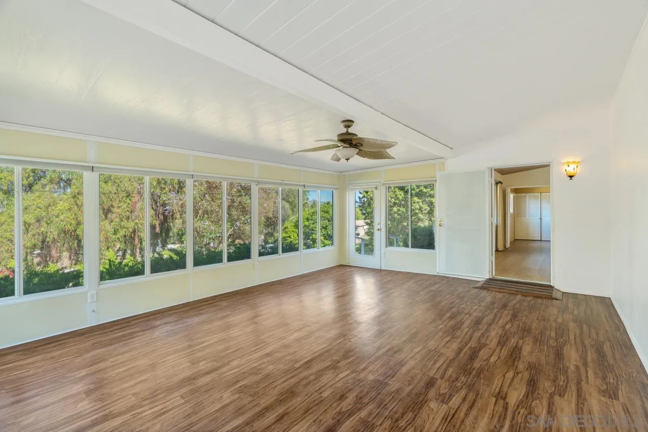 8670 Golden Ridge Road Lakeside, CA 92040 - Photo 9 of 31 a view of an empty room with wooden floor and a window