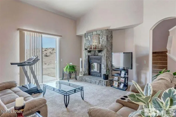 a living room with furniture a dining table and a potted plant