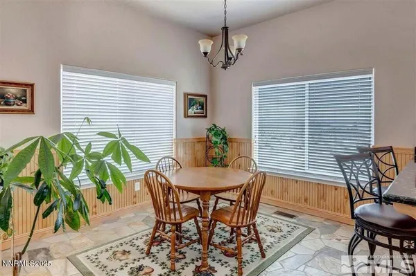 a view of a dining room with furniture and window