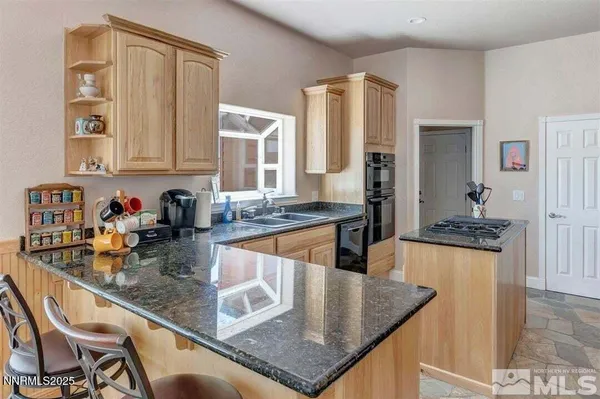 a kitchen with stainless steel appliances granite countertop a sink and a white cabinets