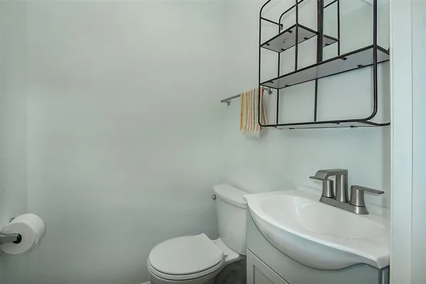 a white toilet sitting next to a bathroom sink