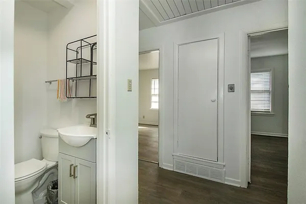 a bathroom with a granite countertop toilet and a sink