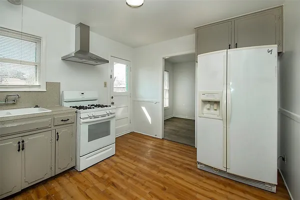 a kitchen with a stove a refrigerator and a sink